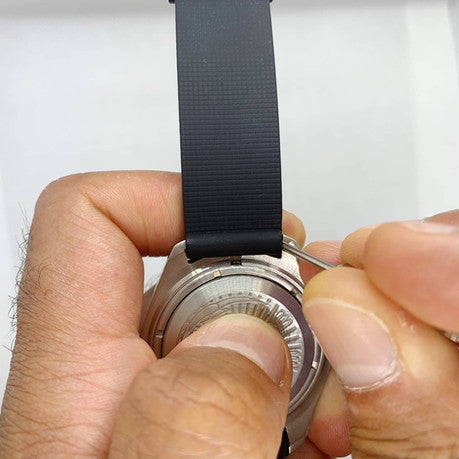Placing Spring Bar Tool into groove of spring bar to remove watch strap from watch