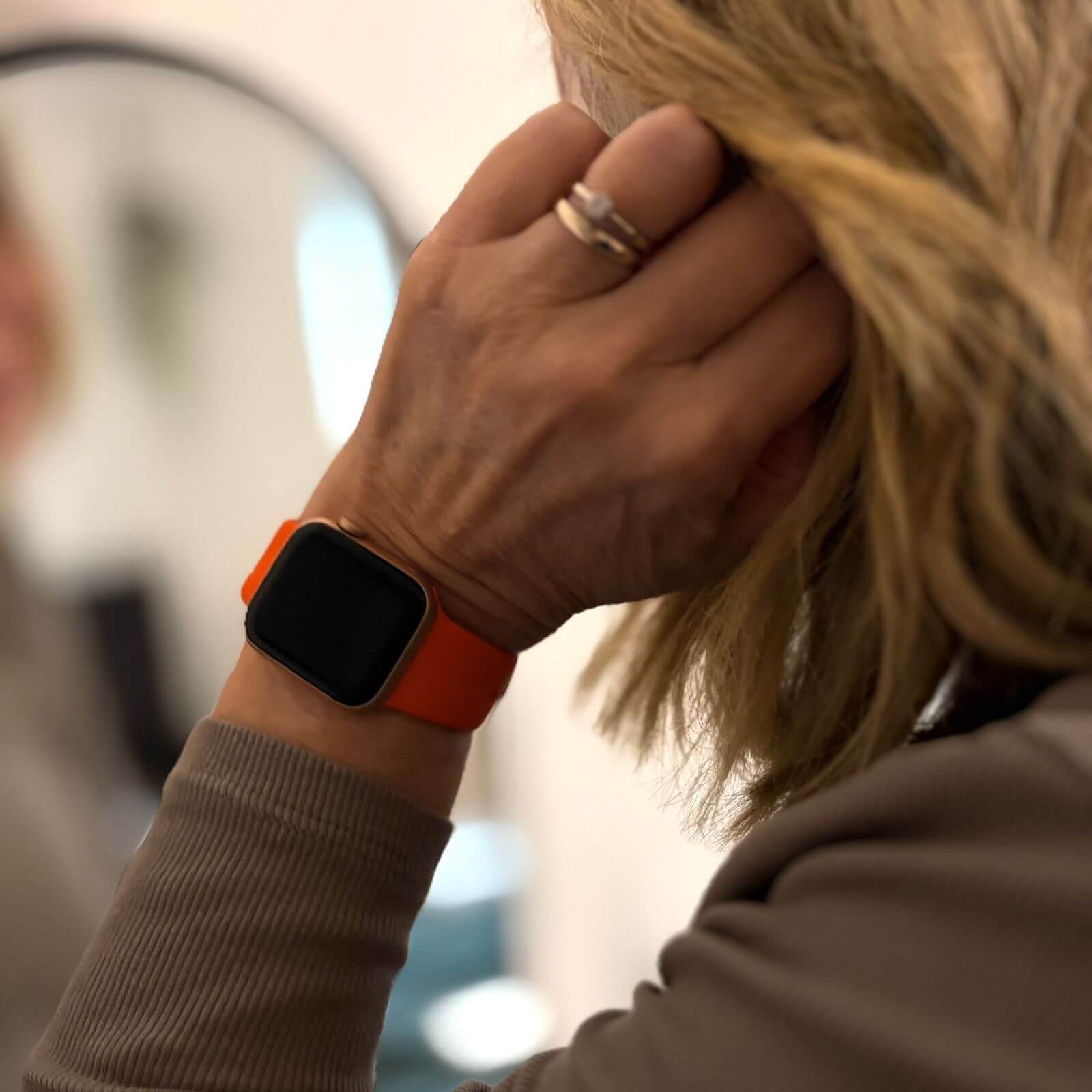 Lady Wearing Orange Silicone Apple Watch Strap From The Thrifty Gentleman