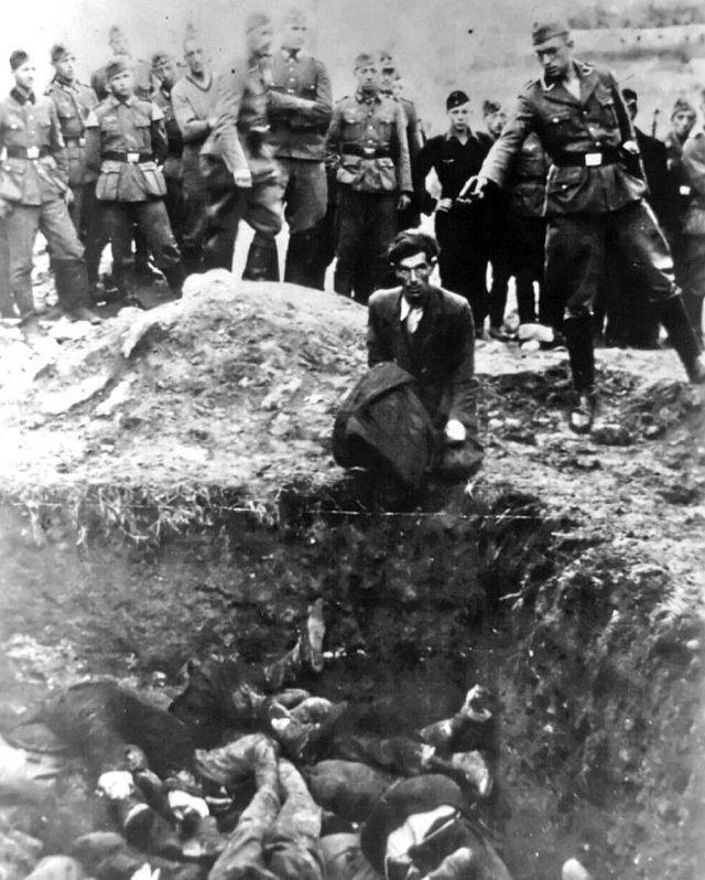 Jewish man, kneeling before a pit filled with bodies, about to be shot by a German soldier