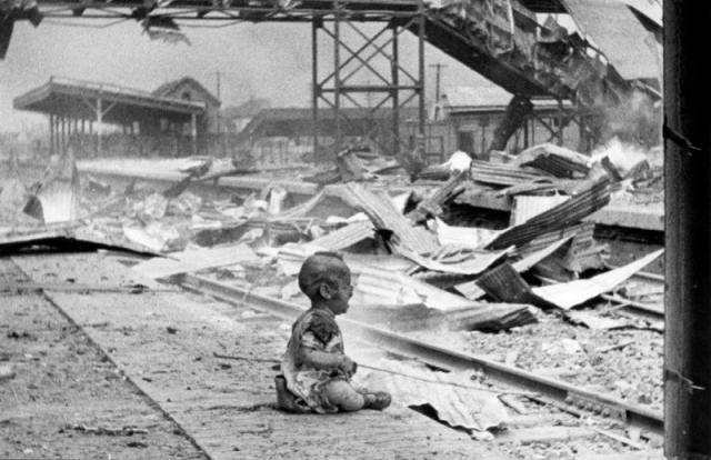 An injured baby cries at a shattered Shanghai South railway station, aftermath of bombed attacked in 1937