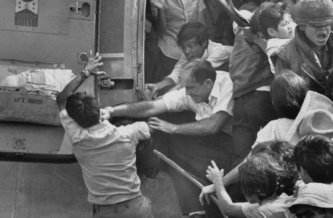 An American evacuee punches away a South Vietnamese man who was trying to get in for a place on the last chopper out of the US embassy in 1975