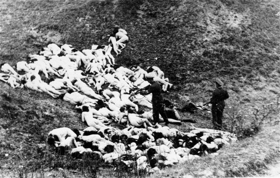 In October of 1942, a German military shoots at a Jewish lady after a mass execution in Mizocz, Ukraine